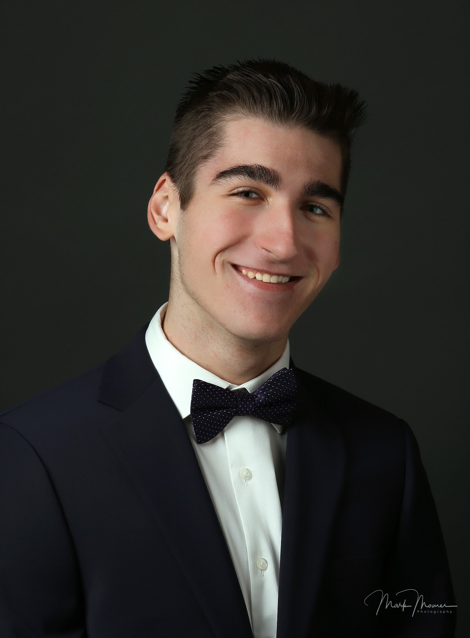 Senior portrait — Alex in suit and bow tie studio headshot